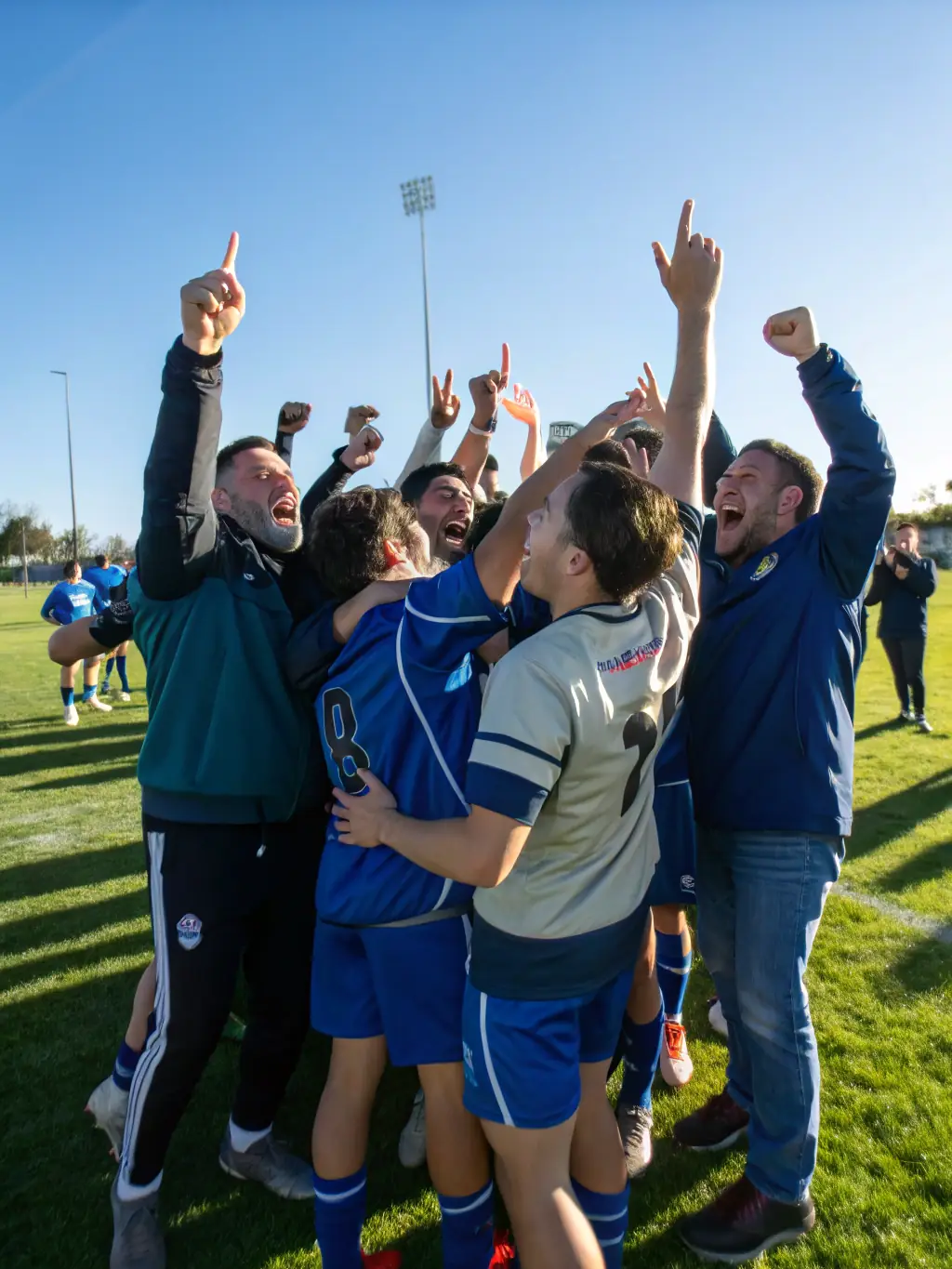 A diverse team of students celebrating a victory after a sports match, highlighting the importance of teamwork and camaraderie fostered by Dynamic Club.
