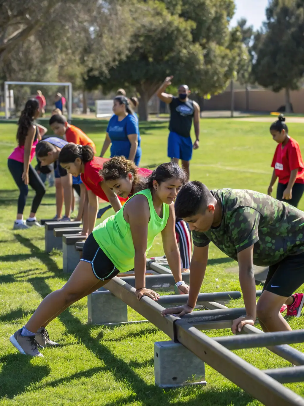 Students laughing and engaging in a fun fitness activity outdoors, emphasizing the promotion of healthy habits and an active lifestyle at Dynamic Club.